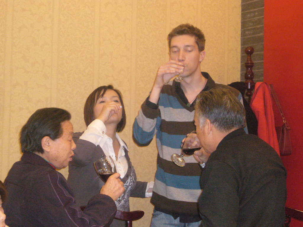 Tim, Miaomiao and Miaomiao`s grandparents having drinks in a restaurant in the city center