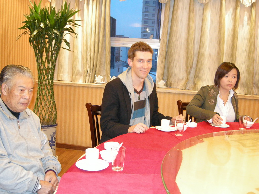 Tim, Miaomiao and Miaomiao`s grandfather in a restaurant in the city center