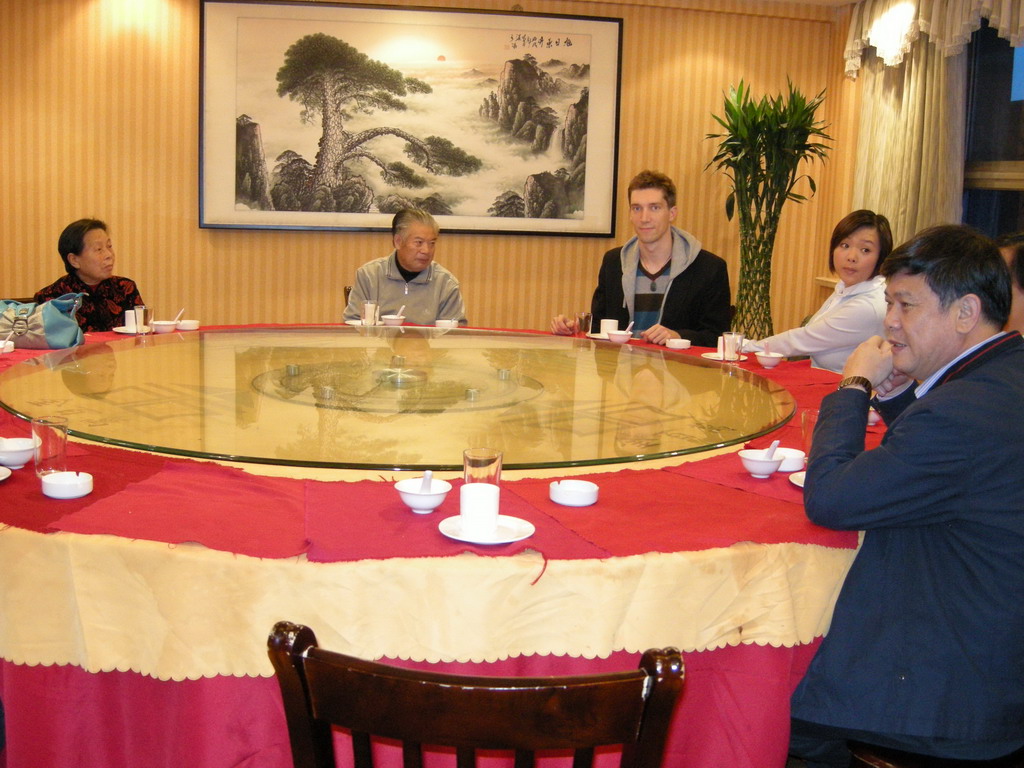 Tim, Miaomiao and Miaomiao`s parents and grandparents in a restaurant in the city center