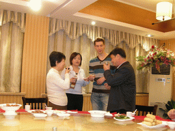 Tim, Miaomiao and Miaomiao`s parents having drinks in a restaurant in the city center
