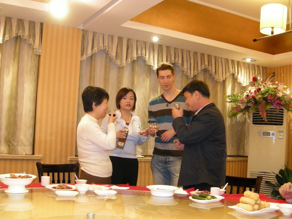 Tim, Miaomiao and Miaomiao`s parents having drinks in a restaurant in the city center