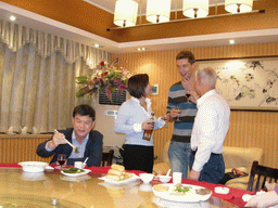 Tim, Miaomiao and Miaomiao`s father and uncle having drinks in a restaurant in the city center