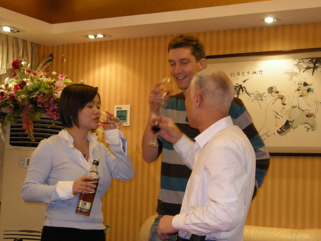 Tim, Miaomiao and Miaomiao`s uncle having drinks in a restaurant in the city center