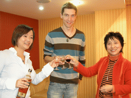 Tim, Miaomiao and Miaomiao`s aunt having drinks in a restaurant in the city center