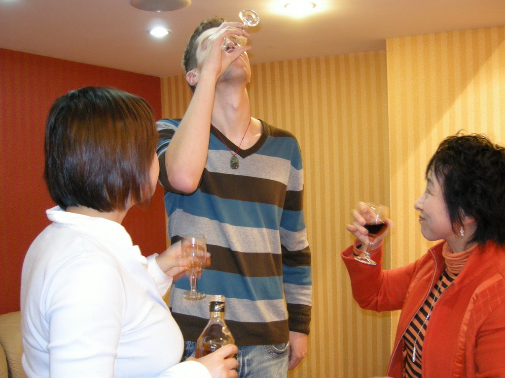 Tim, Miaomiao and Miaomiao`s aunt having drinks in a restaurant in the city center