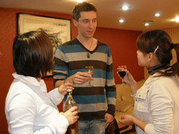 Tim, Miaomiao and Miaomiao`s cousin having drinks in a restaurant in the city center