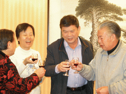 Miaomiao`s parents and grandparents having drinks in a restaurant in the city center