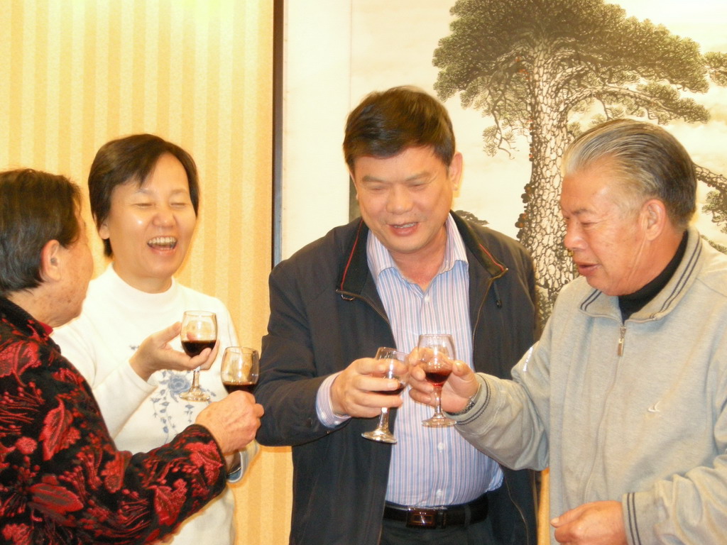 Miaomiao`s parents and grandparents having drinks in a restaurant in the city center