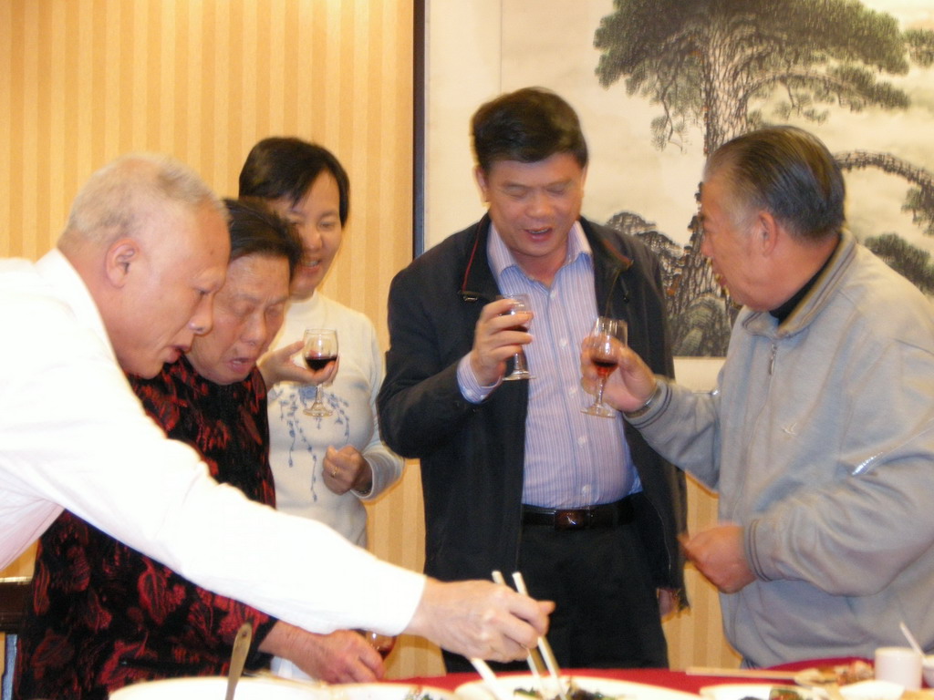 Miaomiao`s parents, grandparents and uncle having drinks in a restaurant in the city center