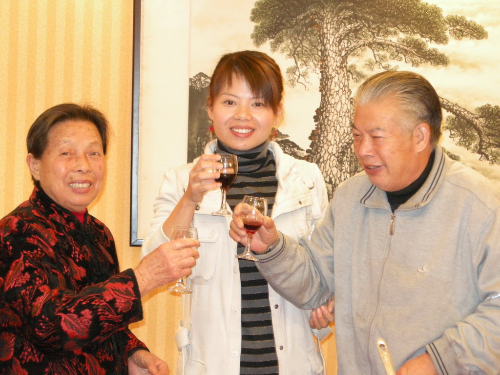 Miaomiao`s grandparents and cousin having drinks in a restaurant in the city center