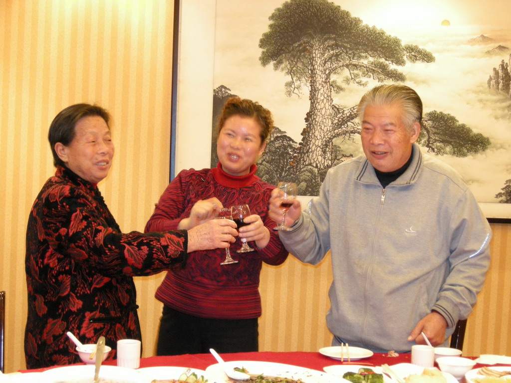 Miaomiao`s grandparents and a family member having drinks in a restaurant in the city center
