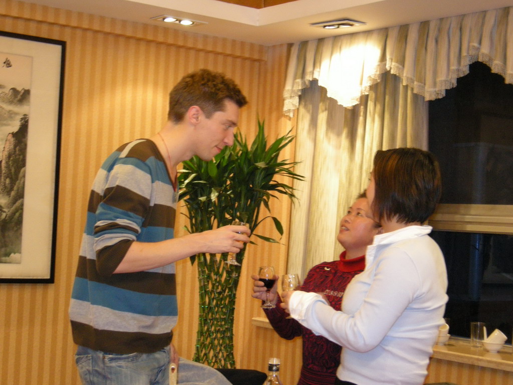 Tim, Miaomiao and a family member having drinks in a restaurant in the city center