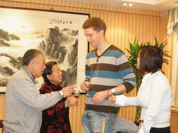 Tim, Miaomiao and Miaomiao`s grandparents having drinks in a restaurant in the city center