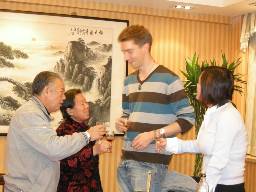 Tim, Miaomiao and Miaomiao`s grandparents having drinks in a restaurant in the city center