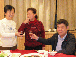 Miaomiao`s parents and a family member having drinks in a restaurant in the city center
