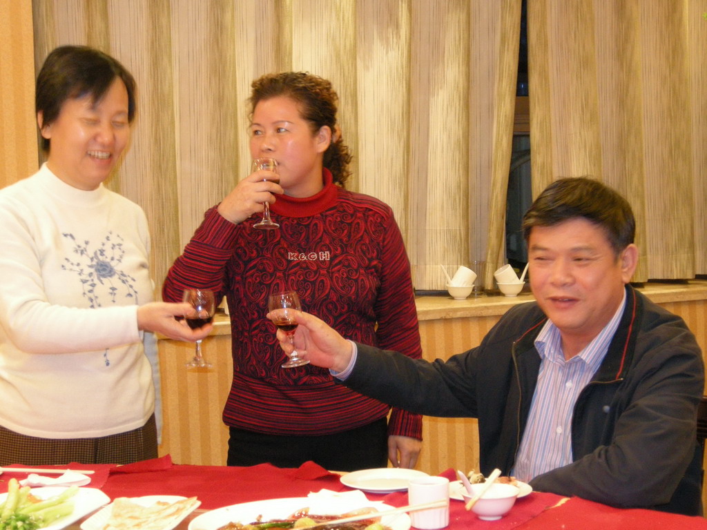Miaomiao`s parents and a family member having drinks in a restaurant in the city center