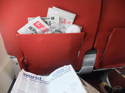 Newspapers in the first class seat in the airplane to Haikou