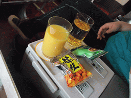Drinks and snacks in the first class seat in the airplane to Haikou