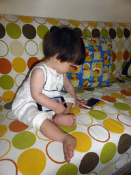 Max playing with iPhones at the apartment of Miaomiao`s uncle and aunt