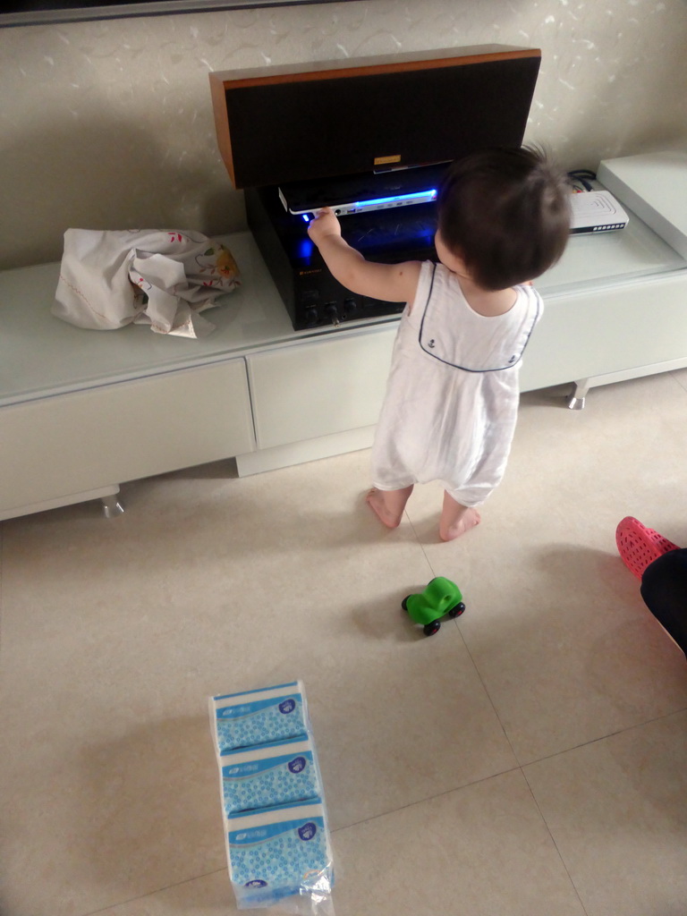 Max playing with electronics at the apartment of Miaomiao`s uncle and aunt