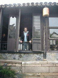 Tim in the window of a house at the Zhouzhuang Water Town