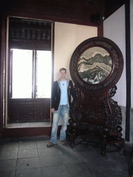 Tim with a piece of art in a house at the Zhouzhuang Water Town