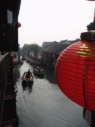 Lantern and a canal with boats at the Zhouzhuang Water Town