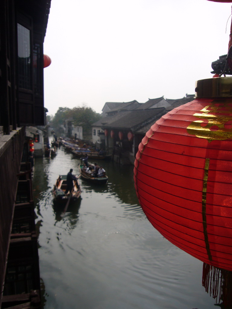 Lantern and a canal with boats at the Zhouzhuang Water Town