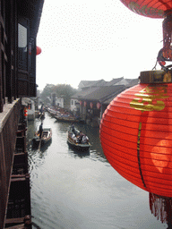 Lantern and a canal with boats at the Zhouzhuang Water Town