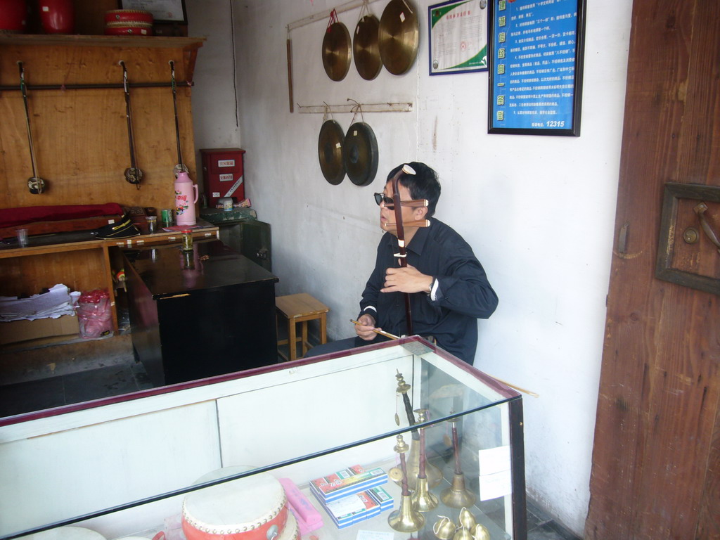 Man playing a musical instrument at the Zhouzhuang Water Town