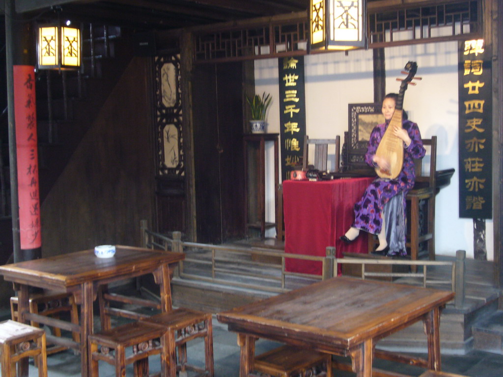 Woman playing a musical instrument at the Zhouzhuang Water Town