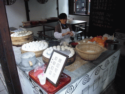 Woman preparing food at the Zhouzhuang Water Town