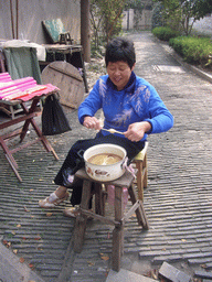 Woman making a lollipop at the Zhouzhuang Water Town