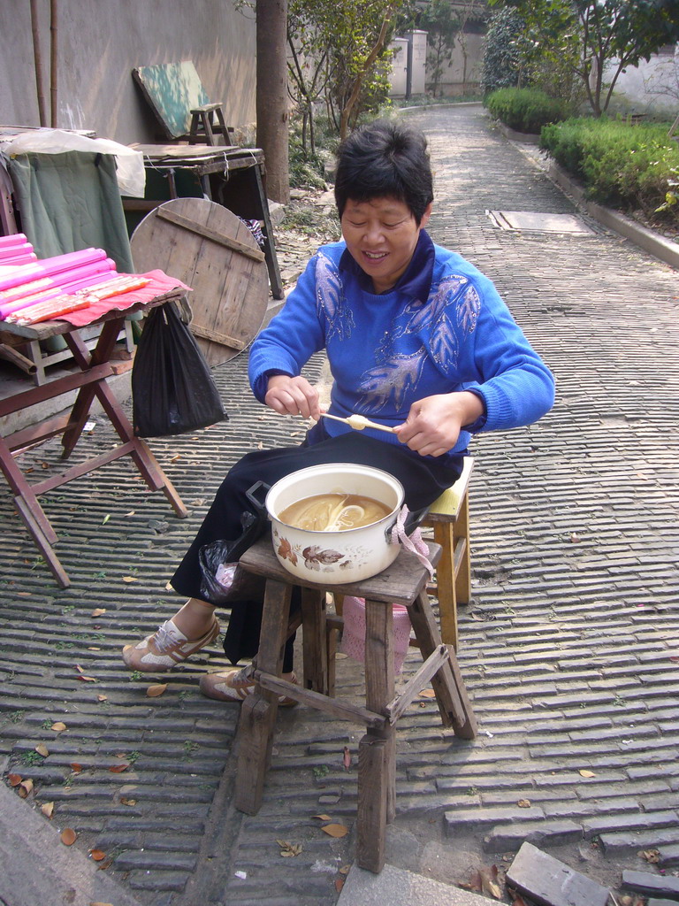 Woman making a lollipop at the Zhouzhuang Water Town