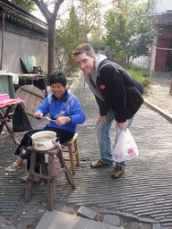 Tim and a woman making a lollipop at the Zhouzhuang Water Town
