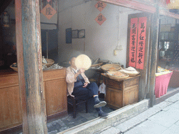Man at a food shop at the Zhouzhuang Water Town