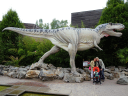 Miaomiao, Max and Max`s grandfather in front of the Tyrannosaurus Rex statue at the main square of Dinoland Zwolle, with explanation