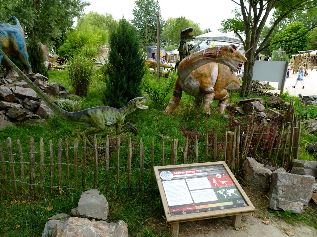 Statues of Deinonychuses attacking a Tenontosaurus at the Cretaceous area at Dinoland Zwolle, with explanation