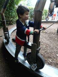 Max at the spider cycle carousel at Dinoland Zwolle
