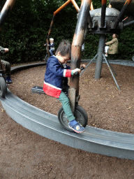 Max at the spider cycle carousel at Dinoland Zwolle