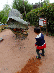 Max with a Postosuchus statue at the Triassic area at Dinoland Zwolle, with explanation