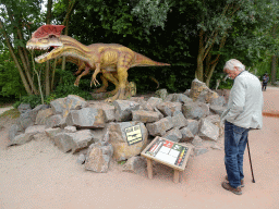 Max`s grandfather with a Dilophosaurus statue at the Triassic area at Dinoland Zwolle, with explanation