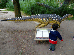 Max with a Scelidosaurus statue at the Jurassic area at Dinoland Zwolle, with explanation