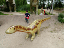 Miaomiao and Max with a dinosaur statue at the Jurassic area at Dinoland Zwolle