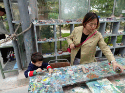 Miaomiao and Max making Dinosaur statuettes from clay at the PaleoLab at Dinoland Zwolle