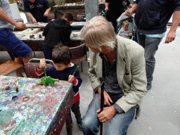 Max and his grandfather painting a Dinosaur statuette made from clay at the PaleoLab at Dinoland Zwolle