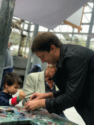 Tim, Max and his grandfather painting a Dinosaur statuette made from clay at the PaleoLab at Dinoland Zwolle