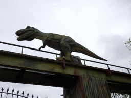 Dinosaur statue on top of a gate at the entrance of Dinoland Zwolle