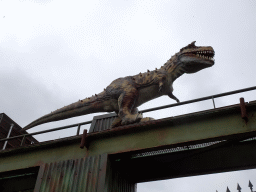 Dinosaur statue on top of a gate at the entrance of Dinoland Zwolle